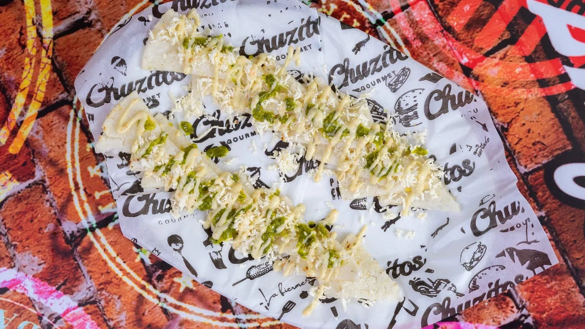 Arepa With Cheese And Chimichurri - Traditional Colombian corn cake with cheese and flavorful chimichurri sauce.